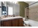 Traditional bathroom with tub-shower combo and dark-stained vanity at 7416 Redhead Dr, North Las Vegas, NV 89084