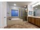 Luxurious bathroom features a soaking tub and glass-enclosed shower at 7416 Redhead Dr, North Las Vegas, NV 89084