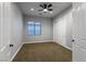 Bedroom featuring neutral carpet, a ceiling fan, and a window for natural light at 7416 Redhead Dr, North Las Vegas, NV 89084