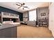 bedroom featuring a bunkbed, dark blue accent wall and a ceiling fan at 7416 Redhead Dr, North Las Vegas, NV 89084