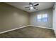 Cozy bedroom with neutral walls, ceiling fan, and a bright window at 7416 Redhead Dr, North Las Vegas, NV 89084