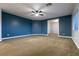 Spacious bedroom featuring a blue accent wall and carpet at 7416 Redhead Dr, North Las Vegas, NV 89084