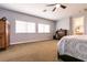 Spacious bedroom featuring a ceiling fan, plush carpet, and ensuite bathroom access at 7416 Redhead Dr, North Las Vegas, NV 89084