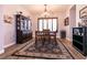 Traditional dining room featuring a decorative chandelier, wood floors, and attractive area rug at 7416 Redhead Dr, North Las Vegas, NV 89084