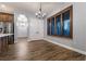 Dining area with a chandelier, wood-look tile flooring, and natural light at 7416 Redhead Dr, North Las Vegas, NV 89084