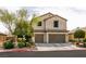Charming two-story home features a three-car garage and well-manicured landscaping at 7416 Redhead Dr, North Las Vegas, NV 89084