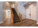 Open foyer with staircase, double-door entry, and wood-look tile flooring at 7416 Redhead Dr, North Las Vegas, NV 89084