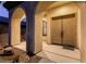 Inviting front entrance with stately double doors and stone accents under arched porch at 7416 Redhead Dr, North Las Vegas, NV 89084
