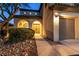 Charming home showcasing a covered entryway, mature landscaping, and two-car garage at 7416 Redhead Dr, North Las Vegas, NV 89084