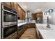 Modern kitchen with stainless steel appliances, custom cabinetry, and elegant countertops at 7416 Redhead Dr, North Las Vegas, NV 89084