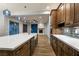 Kitchen with stainless steel appliances, white countertops, and an open view to the living room at 7416 Redhead Dr, North Las Vegas, NV 89084