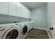 A bright laundry room features modern appliances, ample counter space, and stylish wood flooring at 7416 Redhead Dr, North Las Vegas, NV 89084