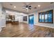 Open-concept living space with hardwood floors connecting kitchen, dining, and living areas at 7416 Redhead Dr, North Las Vegas, NV 89084
