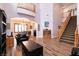 Open-concept living room with high ceilings, a staircase, and seamless access to the dining area at 7416 Redhead Dr, North Las Vegas, NV 89084