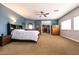 Spacious main bedroom with a ceiling fan, a closet, and ensuite bathroom at 7416 Redhead Dr, North Las Vegas, NV 89084
