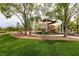 A vibrant community playground with slides, climbing structures, and a cushioned play surface at 7416 Redhead Dr, North Las Vegas, NV 89084