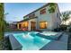 Resort style pool and spa in backyard, framed by stone coping and a covered patio at 7416 Redhead Dr, North Las Vegas, NV 89084