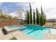 This backyard pool has a spa and tall, thin trees at 7416 Redhead Dr, North Las Vegas, NV 89084