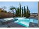 A luxurious pool and spa with elegant stonework and lush landscaping offers a private retreat at 7416 Redhead Dr, North Las Vegas, NV 89084