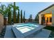 A backyard with a relaxing pool and spa combination, next to a covered outdoor living space at 7416 Redhead Dr, North Las Vegas, NV 89084