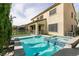 Inviting pool and spa with a -safe fence and turf area, perfect for outdoor enjoyment at 7416 Redhead Dr, North Las Vegas, NV 89084