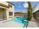 This pool has a spa and rock landscaping, along with a backyard fence at 7416 Redhead Dr, North Las Vegas, NV 89084
