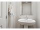 This bathroom features a stylish pedestal sink, a modern faucet, and a convenient towel rack at 9068 Lennon Ln, Las Vegas, NV 89113