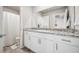 Bathroom vanity featuring granite countertops and a well-lit mirror at 9068 Lennon Ln, Las Vegas, NV 89113