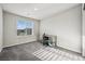 Bright bedroom featuring a window for natural light and a gray carpeted floor at 9068 Lennon Ln, Las Vegas, NV 89113