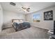 Cozy bedroom with carpet, featuring a ceiling fan and natural light from the window at 9068 Lennon Ln, Las Vegas, NV 89113