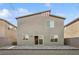 Exterior shot showcasing a backyard with a paved patio and desert landscaping, creating a serene outdoor space at 9068 Lennon Ln, Las Vegas, NV 89113