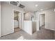 Upstairs hallway with laundry room and multiple doorways creating an open and bright space at 9068 Lennon Ln, Las Vegas, NV 89113
