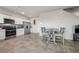Open kitchen boasts stainless steel appliances, white cabinets, and an adjacent dining area at 9068 Lennon Ln, Las Vegas, NV 89113