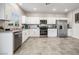 Bright kitchen features stainless steel appliances, granite countertops and white cabinetry at 9068 Lennon Ln, Las Vegas, NV 89113
