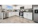 Stylish kitchen offers stainless steel appliances, white cabinetry, and granite countertops at 9068 Lennon Ln, Las Vegas, NV 89113