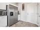 Kitchen area featuring stainless steel refrigerator and access to an exterior door at 9068 Lennon Ln, Las Vegas, NV 89113