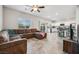 Open concept living room boasts tile floors, a ceiling fan, and modern finishes at 9068 Lennon Ln, Las Vegas, NV 89113