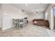 Open floorplan featuring tile flooring, a large sofa, and access to the kitchen and dining area at 9068 Lennon Ln, Las Vegas, NV 89113