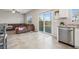 Open floor plan integrates living room with sliding door to backyard and modern kitchen features at 9068 Lennon Ln, Las Vegas, NV 89113