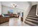 Spacious living room flows to the staircase, providing seamless access to upper levels at 9068 Lennon Ln, Las Vegas, NV 89113