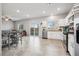 Open concept kitchen and living area with seamless transition to outdoor space and modern appliances at 9068 Lennon Ln, Las Vegas, NV 89113