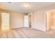 Bright bedroom with neutral walls and carpet with multiple doors at 9115 Canoga Canyon Ct # 102, Las Vegas, NV 89149