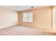 Bright bedroom with neutral walls and carpet, showcasing a window with natural light at 9115 Canoga Canyon Ct # 102, Las Vegas, NV 89149