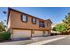 Exterior view of a home with multiple garages at 9115 Canoga Canyon Ct # 102, Las Vegas, NV 89149