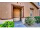 Inviting front entrance with stone accents and landscaped bushes at 9115 Canoga Canyon Ct # 102, Las Vegas, NV 89149