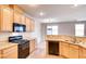 Kitchen with stainless steel appliances and adjacent dining area at 9115 Canoga Canyon Ct # 102, Las Vegas, NV 89149