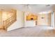 Open-concept living area with staircase and kitchen view at 9115 Canoga Canyon Ct # 102, Las Vegas, NV 89149