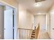 Bright upstairs hallway with staircase, linen closet, and neutral carpet at 9115 Canoga Canyon Ct # 102, Las Vegas, NV 89149