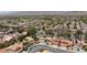 Wide aerial view of a neighborhood with houses, roads, and a mountain range in the distance on a sunny day at 10021 Skipper Ct, Las Vegas, NV 89117