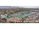 Picturesque aerial view of lakefront homes with private docks nestled among lush greenery and mature palm trees at 10021 Skipper Ct, Las Vegas, NV 89117